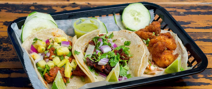 El Guanaco Taqueria signature dishes Three Chicken TacosPupusasSteak Taco